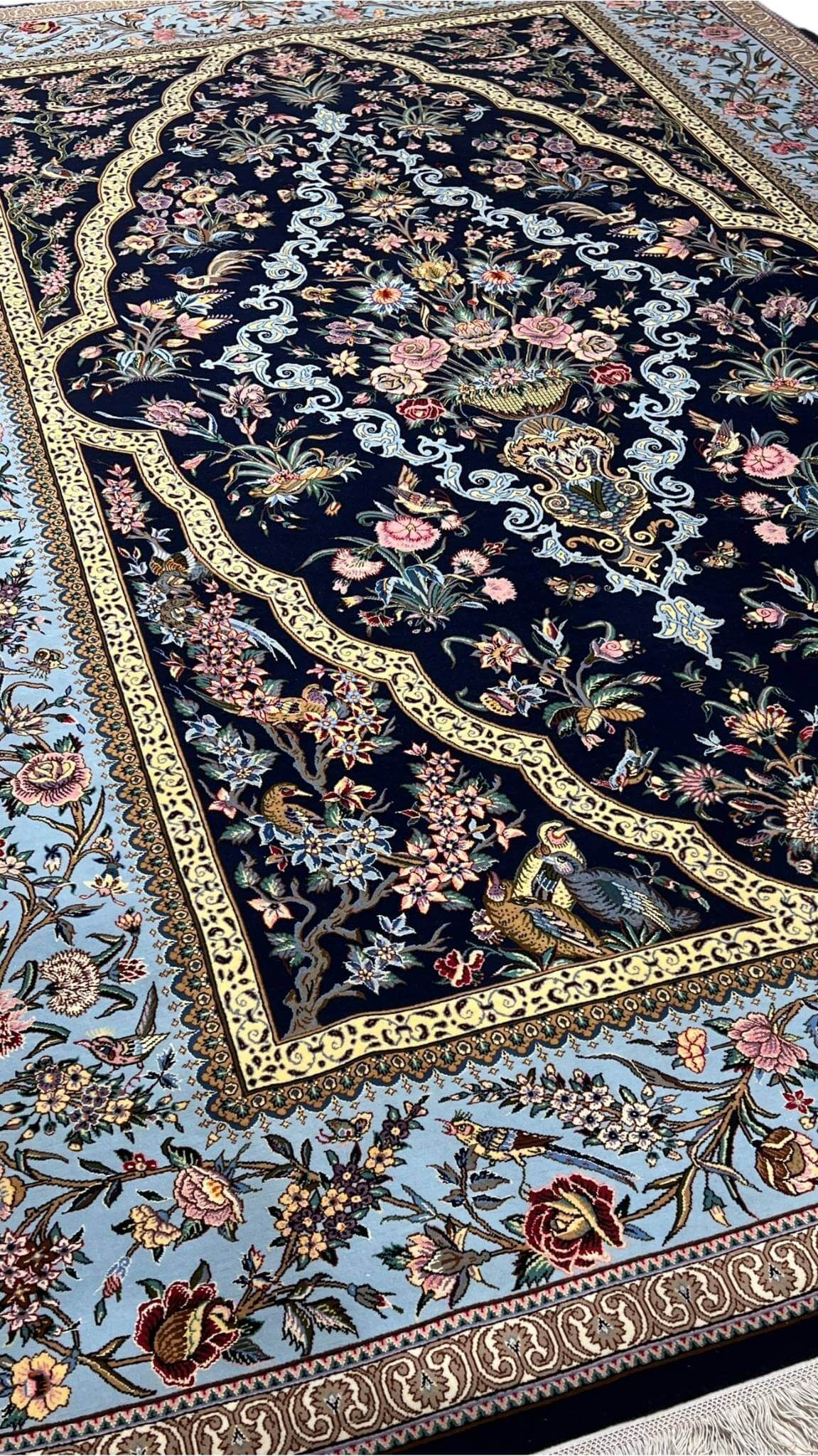 "Elegant Isfahan hand-knotted rug with vibrant floral patterns and detailed peacock designs, 230 x 155 cm."